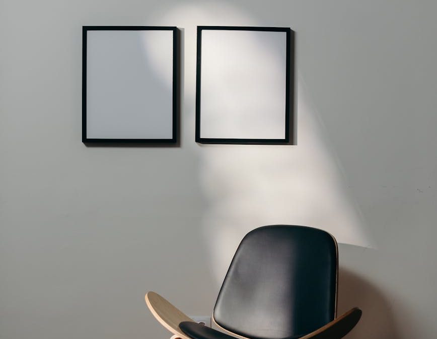 black wooden framed black padded armchair